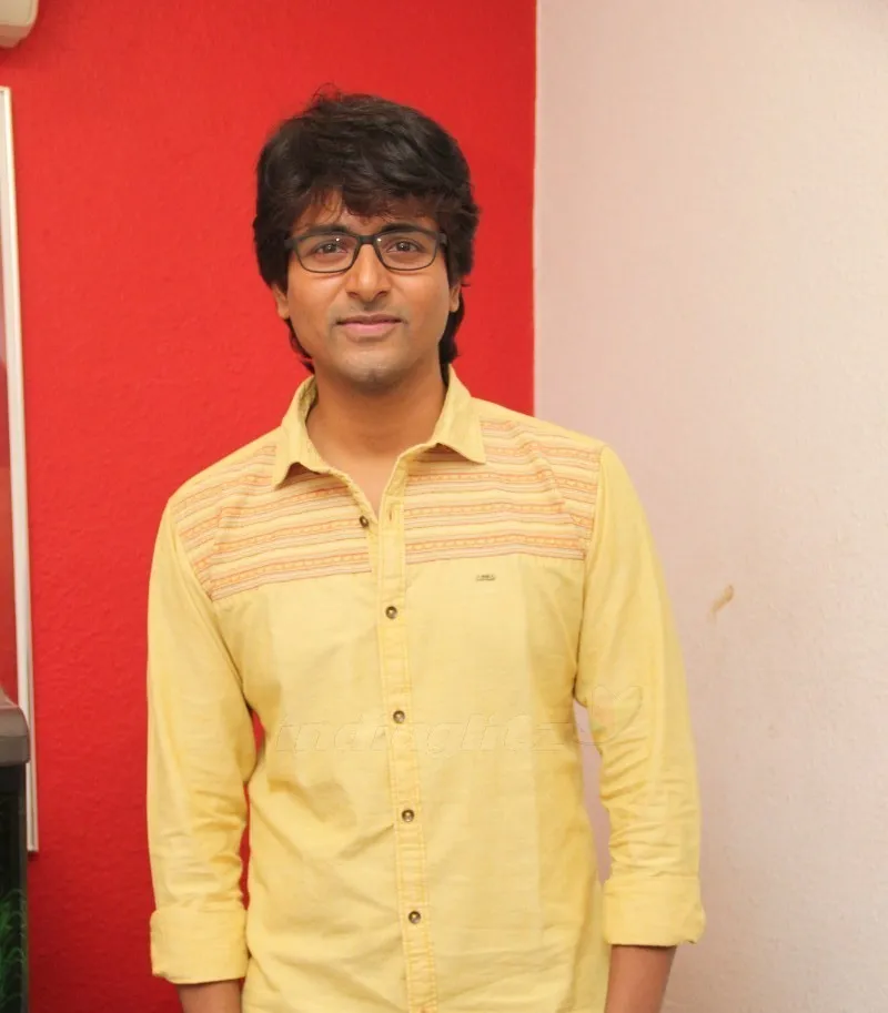 Sivakarthikeyan in Yellow Shirt Standing on Red Pink Backdrop