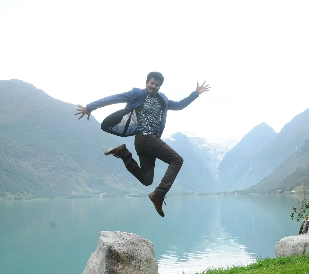 Sivakarthikeyan Jumping Energetically By the Lake Pose Image