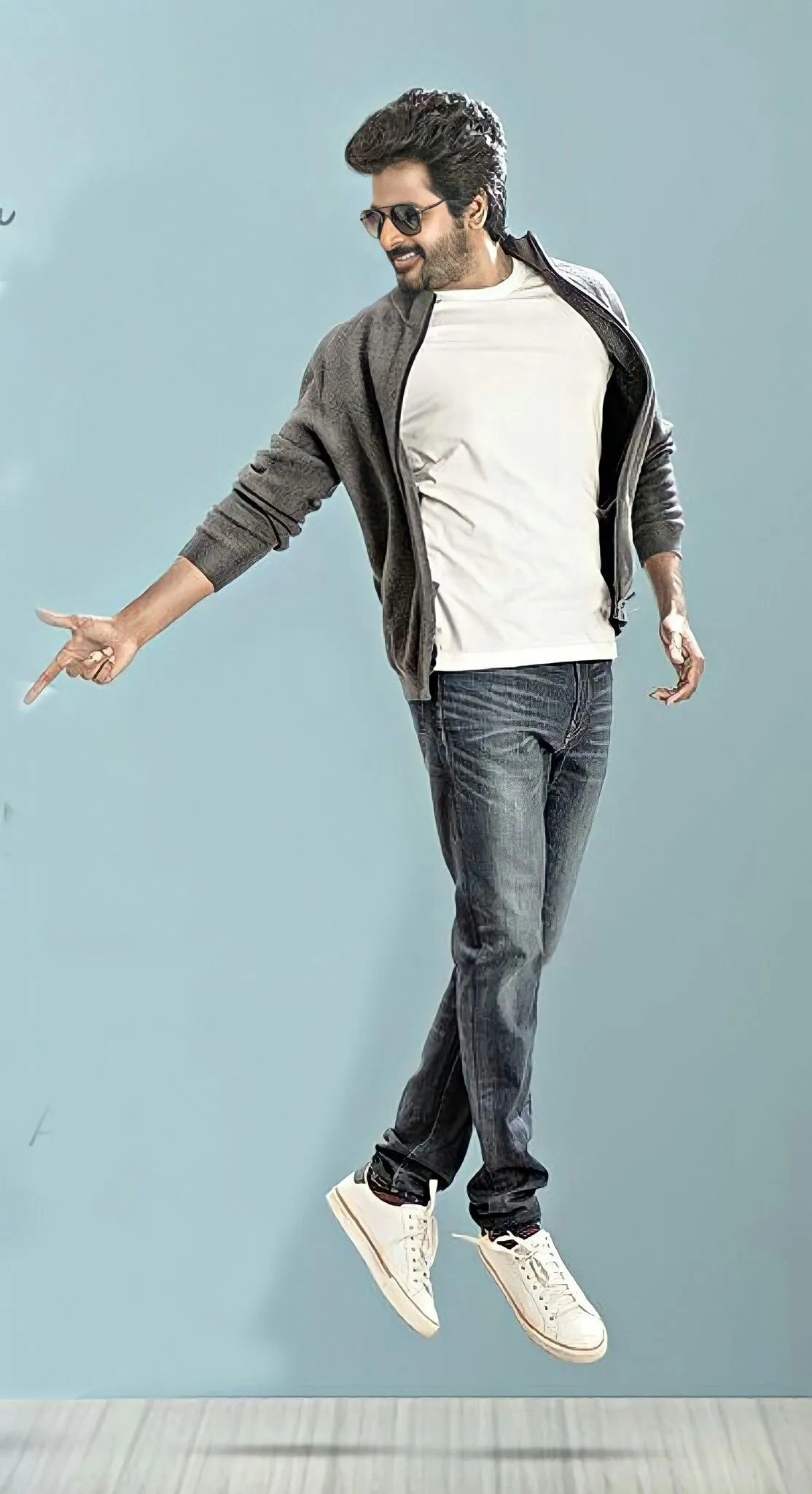 Sivakarthikeyan Jumping on the Studio with a Gray Background