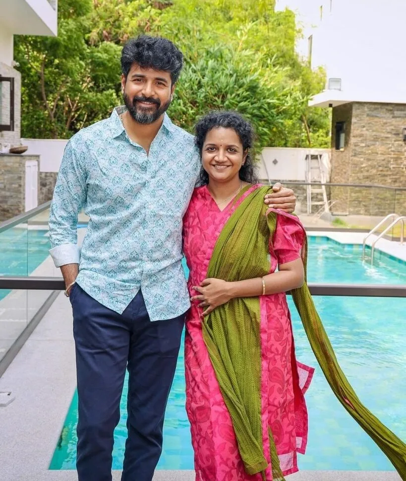 Sivakarthikeyan Posing with His Wife Near Poolside in Daylight