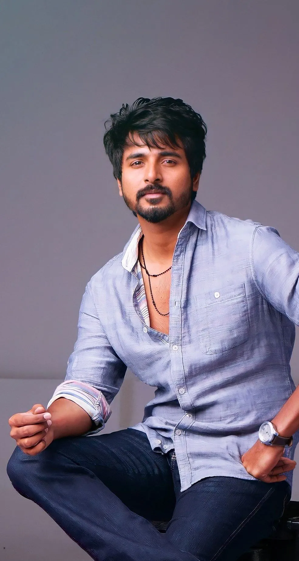 Sivakarthikeyan Relaxed Blue Shirt Sitting Pose from Remo