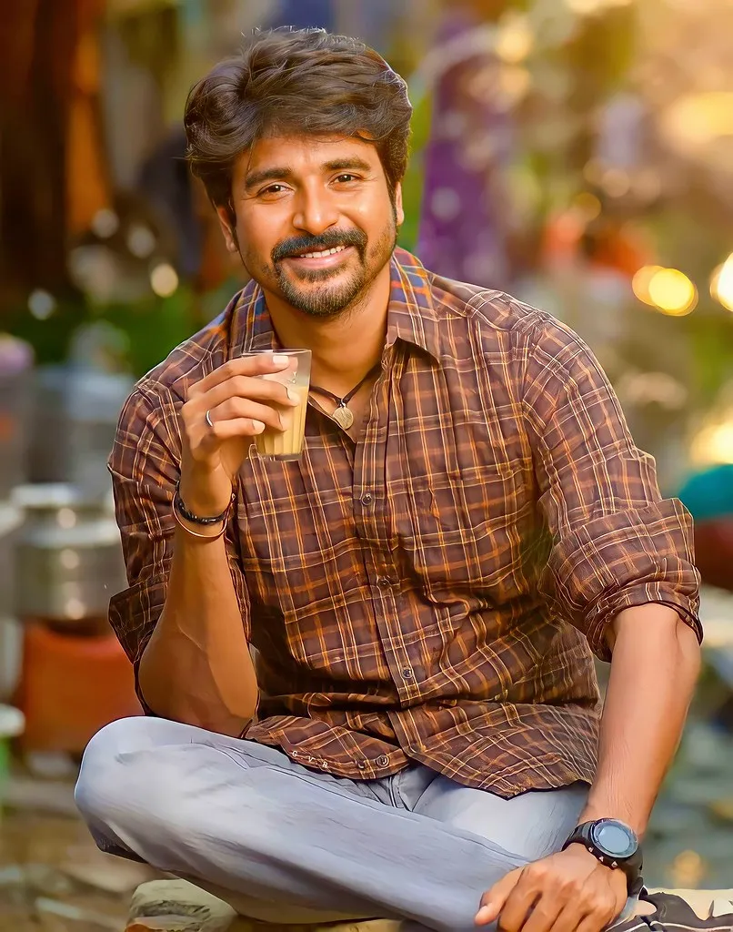 Sivakarthikeyan Sitting Casual with Friendly Smile Wallpaper
