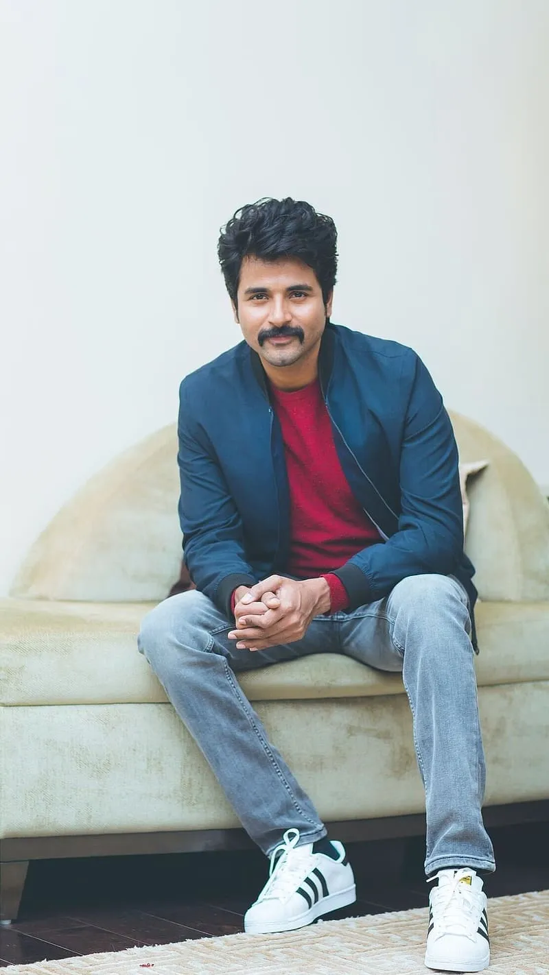 Sivakarthikeyan Sitting on a Cream Colour Sofa Wallpaper