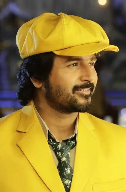 Sivakarthikeyan Wearing Yellow Hat and Jacket and Smiling