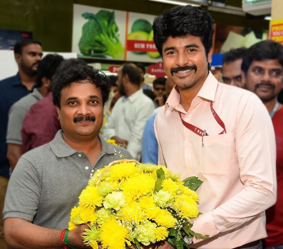 Sk in Pink Shirt Holding a Yellow Colour Flower Bouquet