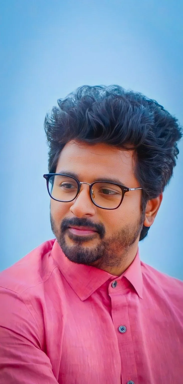 Sk in Pink Shirt with Spectacles Looking Sideways Image