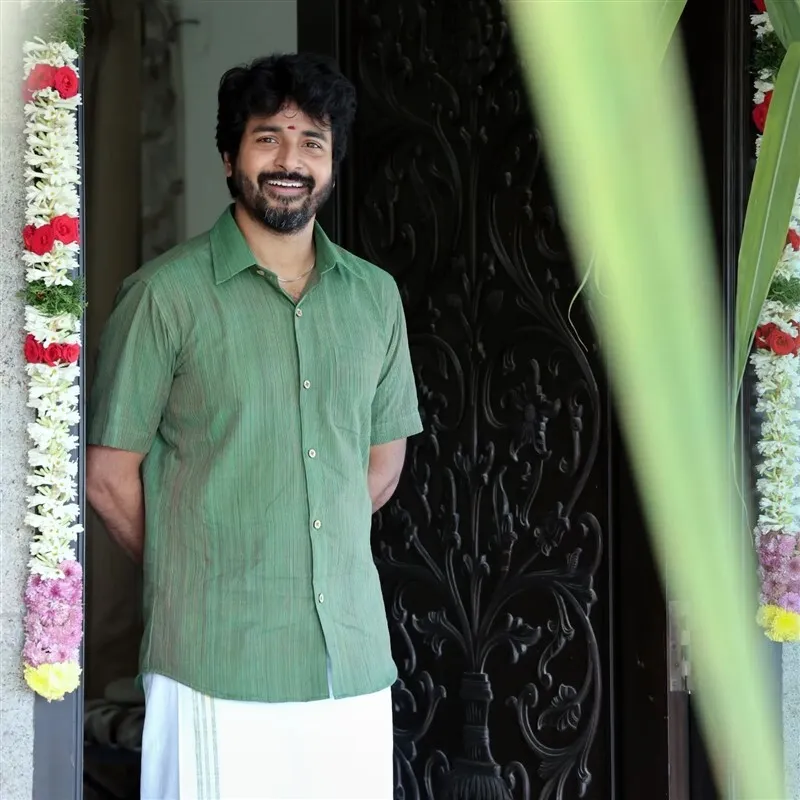 Sk in Traditional Green Shirt Standing By Decorated Entrance