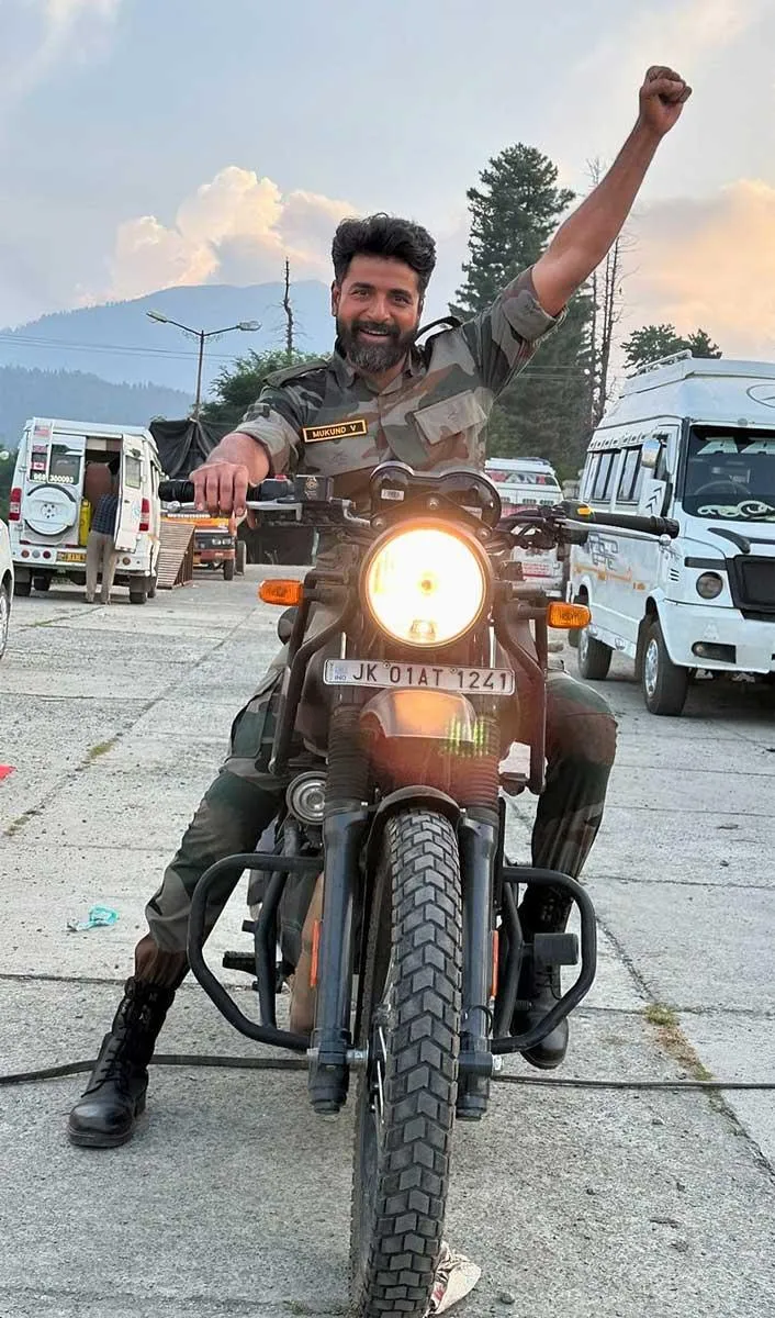Sk Riding Motorcycle with Arm Raised in Victory Gesture