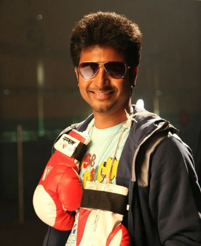 Smiling Pose of Sivakarthikeyan with Boxing Gloves Wallpaper