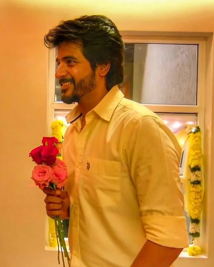 Smiling Sivakarthikeyan Holding Colourful Roses in His Hands