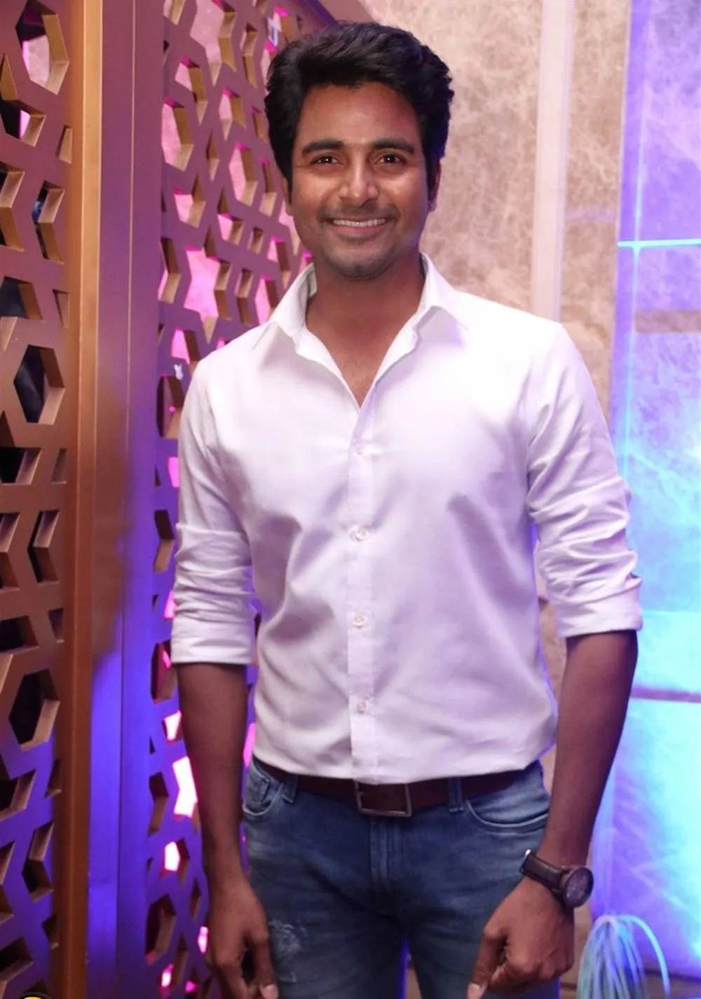Smiling Sivakarthikeyan in White Shirt and Blue Pant Image