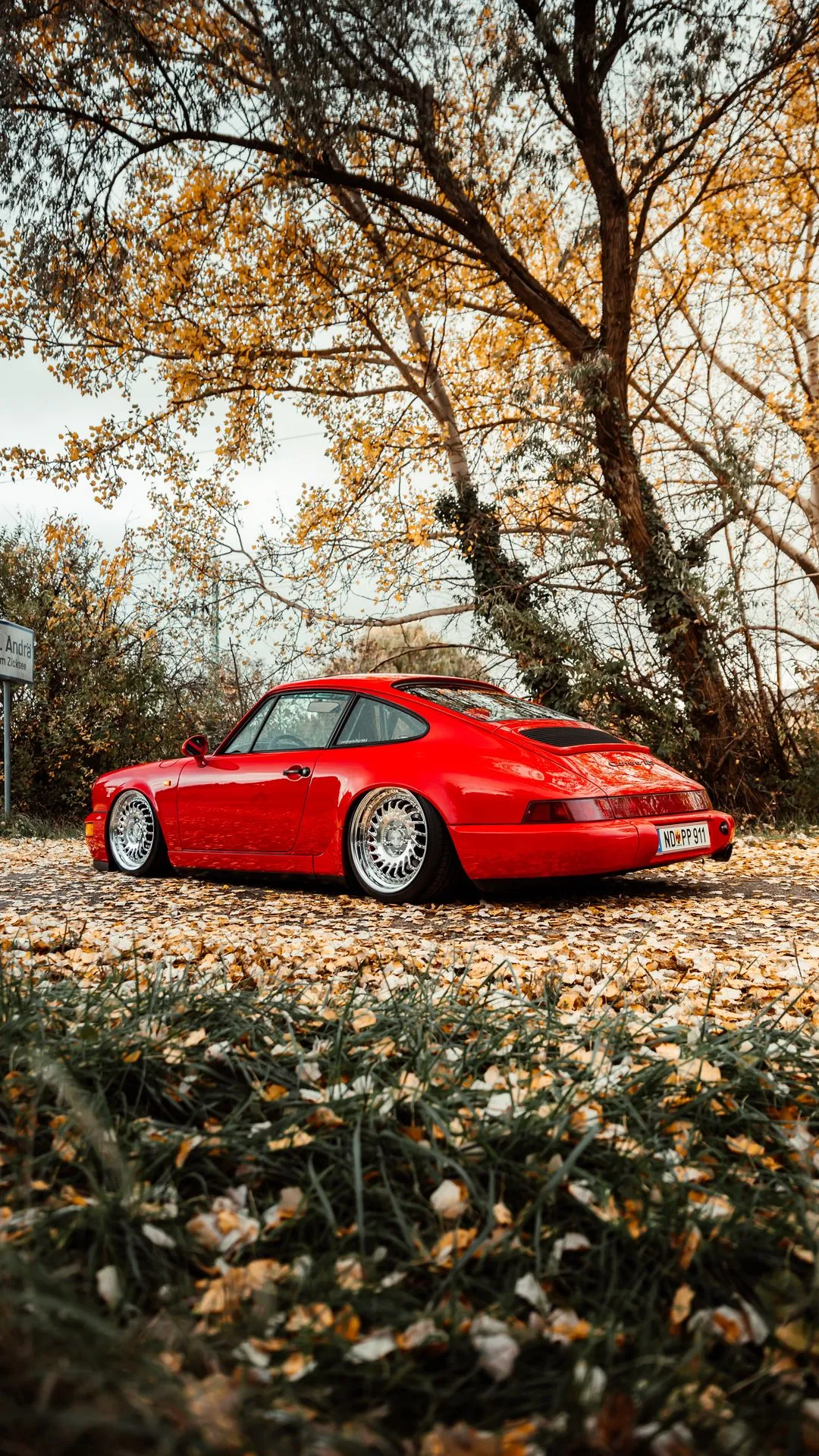 HD wallpaper of classic red porsche parked in autumn forest