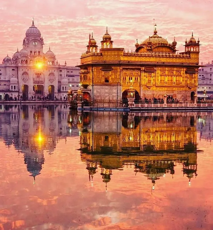 HD Golden temple reflection at sunset across Still Waters