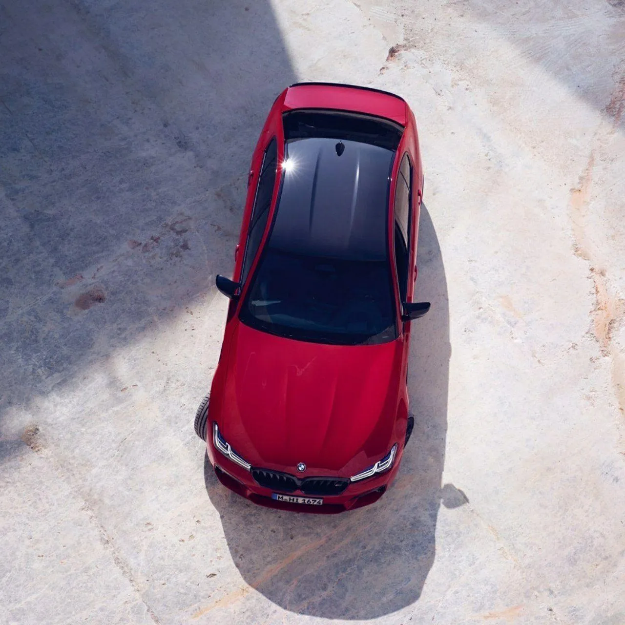 Aerial View of Shiny Red Bmw Car Parked on Pavement