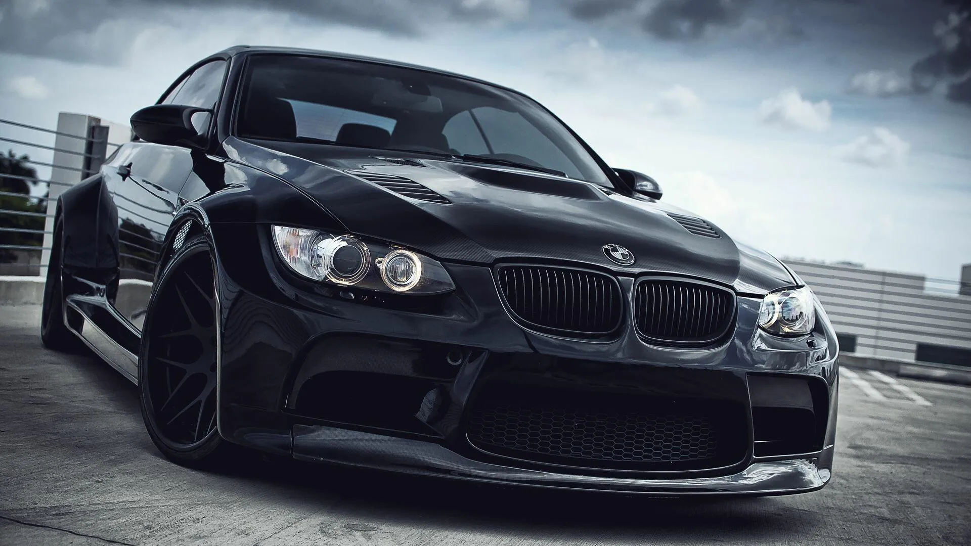 Aggressive Black Bmw Driving on Wet Empty Street Image