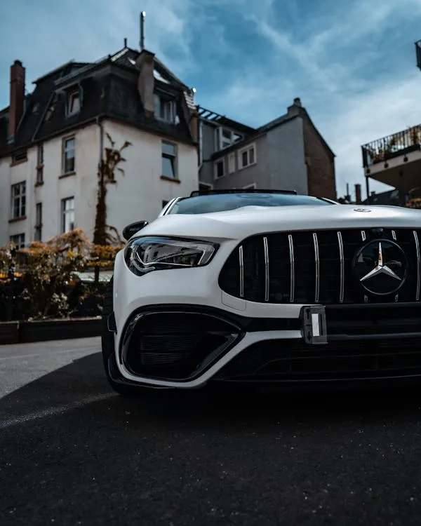 Aggressive Front Look of White AMG Parked Near Buildings