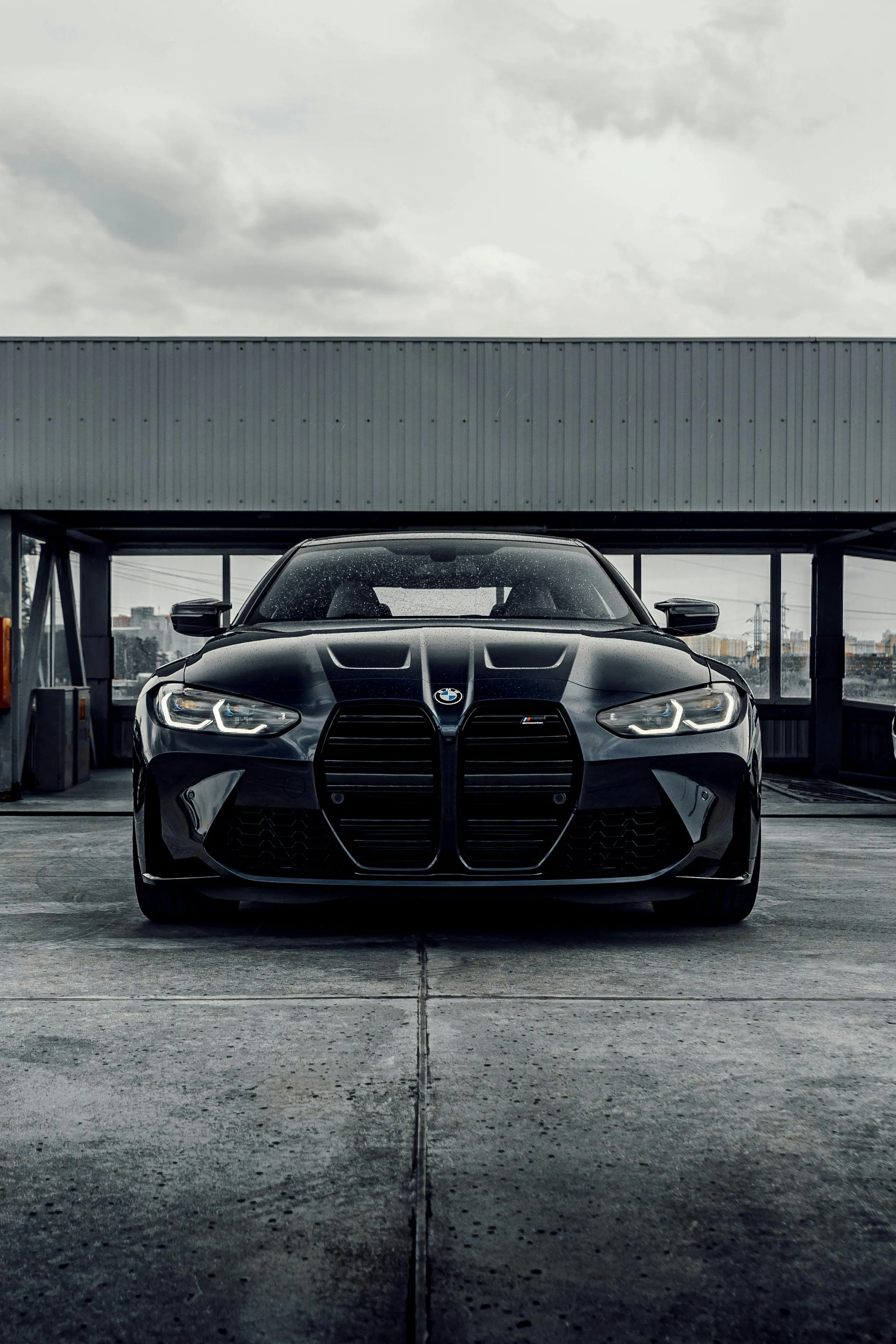 Aggressive Front of Black Bmw Parked on Concrete Surface