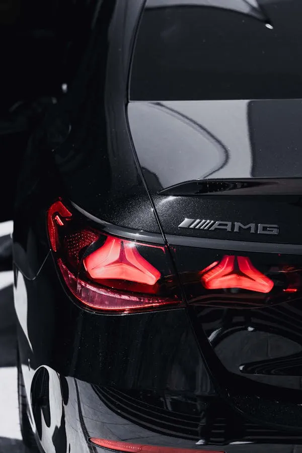 AMG Badge and Tail Light of Black Mercedes Coupe Wallpaper
