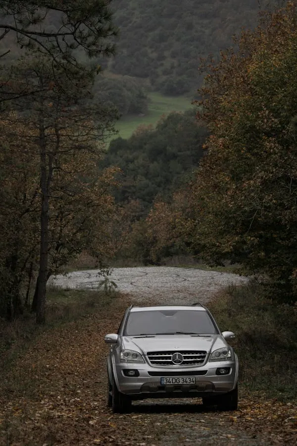 Benz SUV Parked Near Trees by Mountain Trail Path Wallpaper