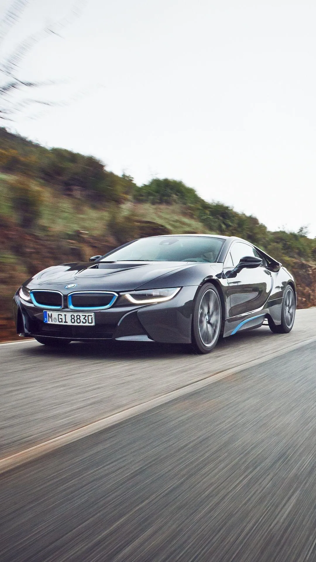 Black and Blue Bmw Sports Car Driving on Winding Road