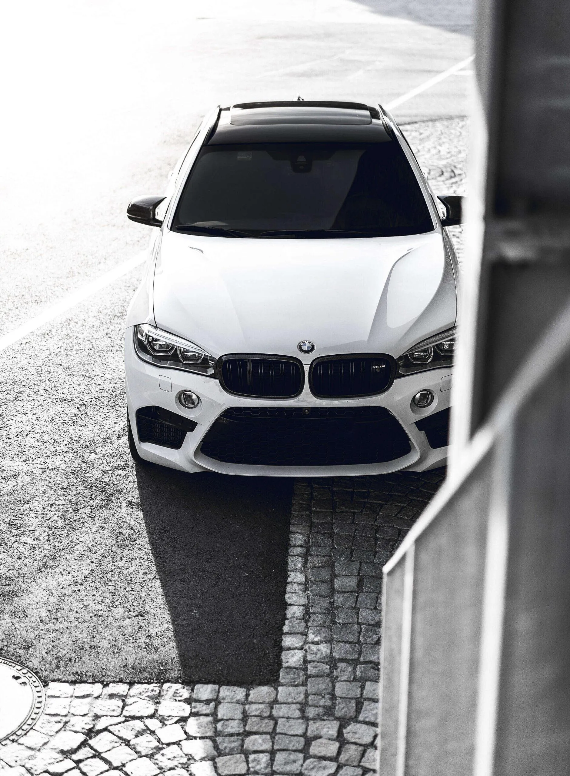 Black and White Bmw Top View Parked Near Street Wallpaper