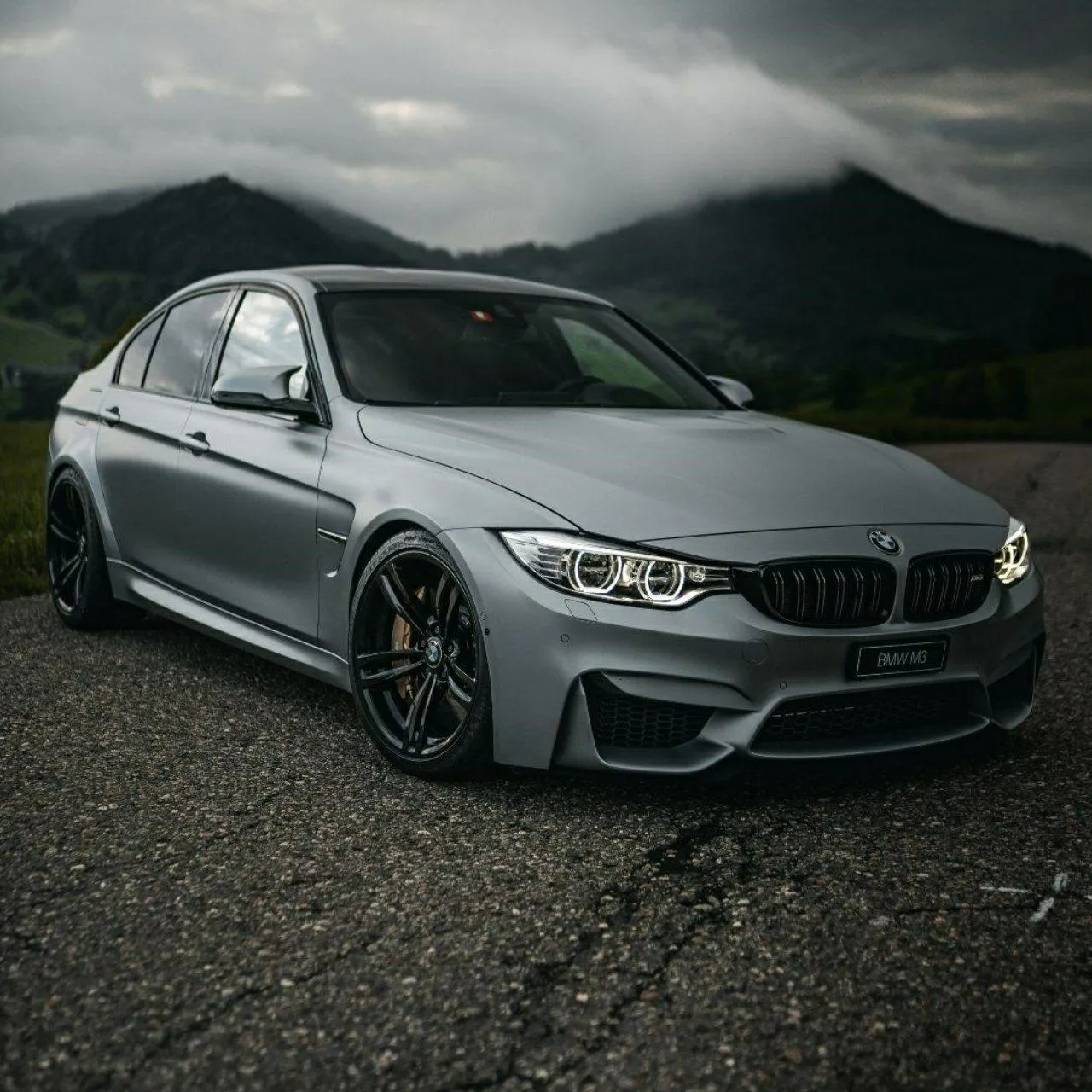 Black and White Image of Bmw Luxury Sedan with Mountain