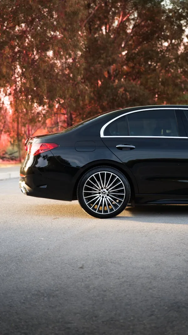 Black Benz Luxury Sedan on Fall Afternoon Street image