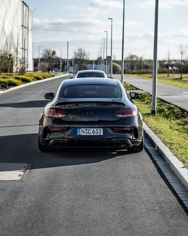 Black Benz Parked on Road with Street Lamps Ahead Wallpaper