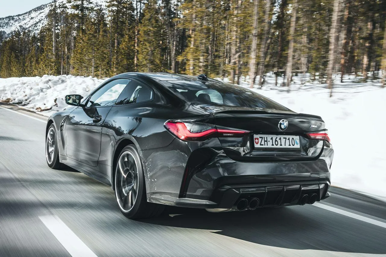 Black Bmw Car Driving on Snow Covered Forest Road Image