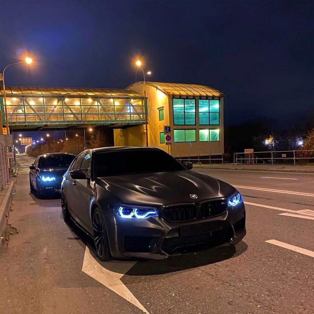 Black Bmw Cars Parked Outside at Night with Bright Lights