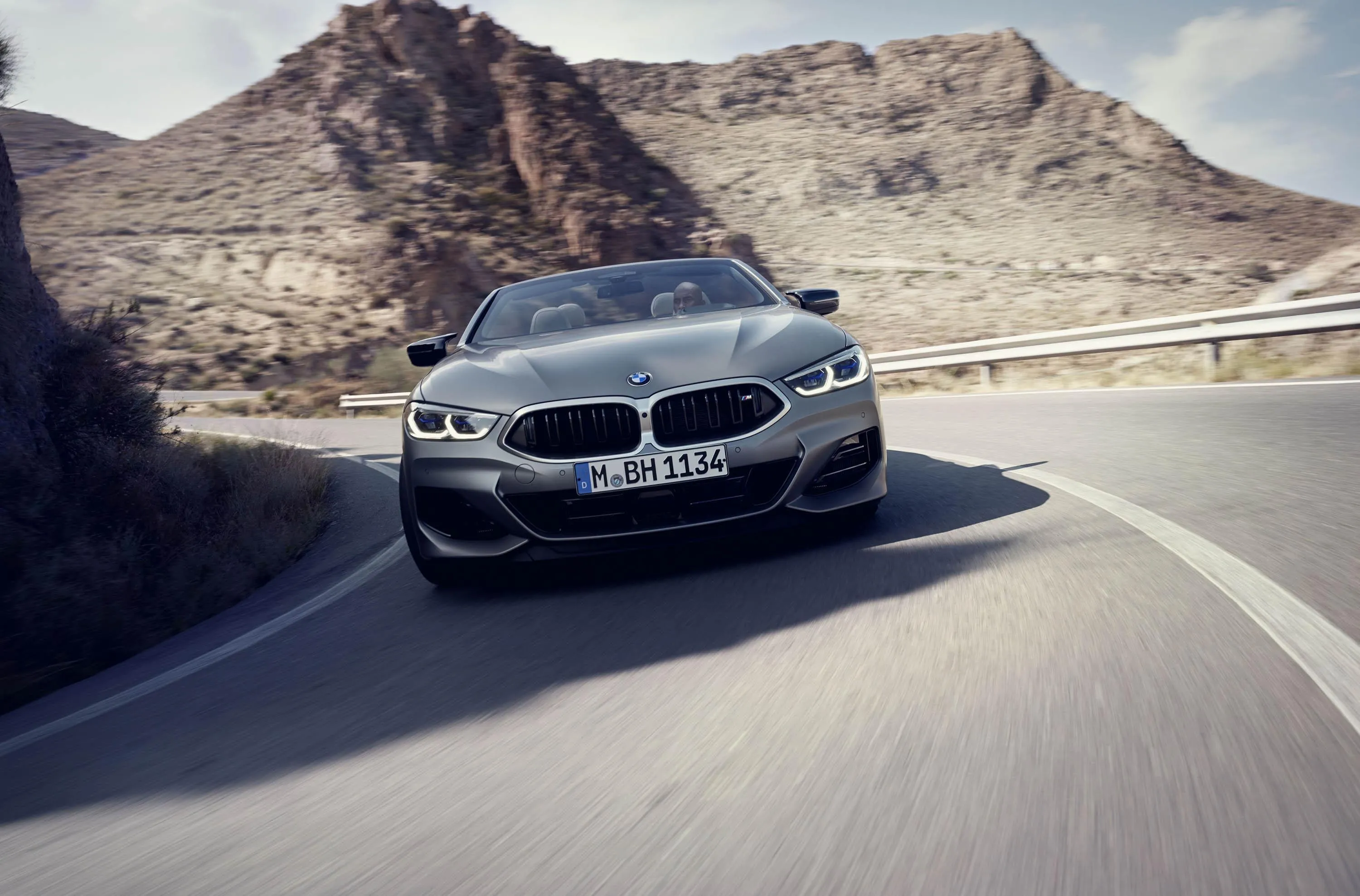 Black Bmw Coupe Driving Fast on Curvy Desert Road Image