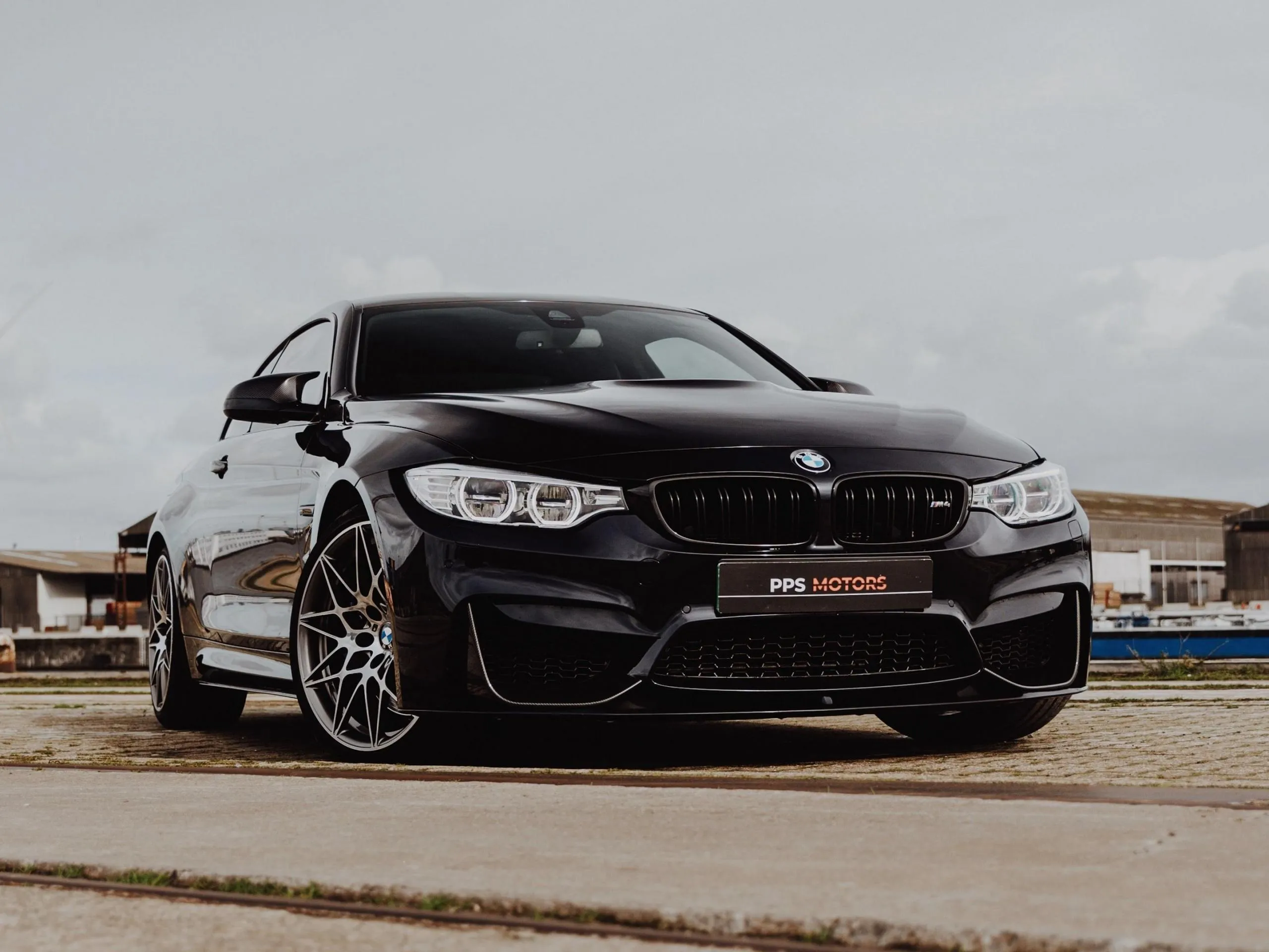 Black Bmw Coupe Parked in Front of Rustic Wall Hd Image