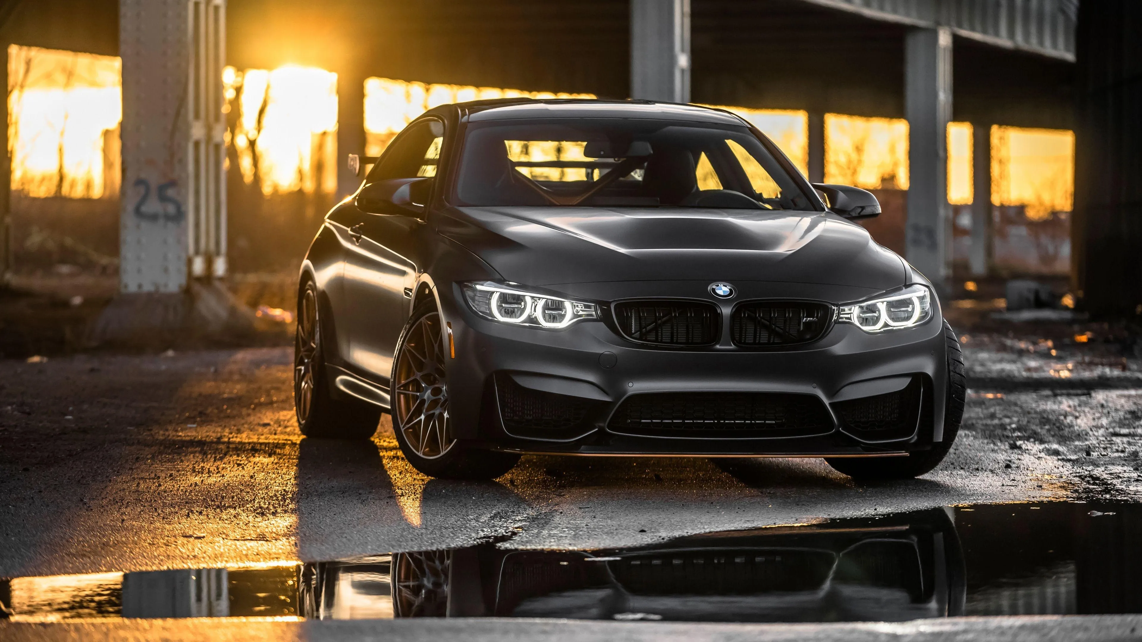 Black Bmw Coupe with Yellow Lights Reflecting on Wet Floor