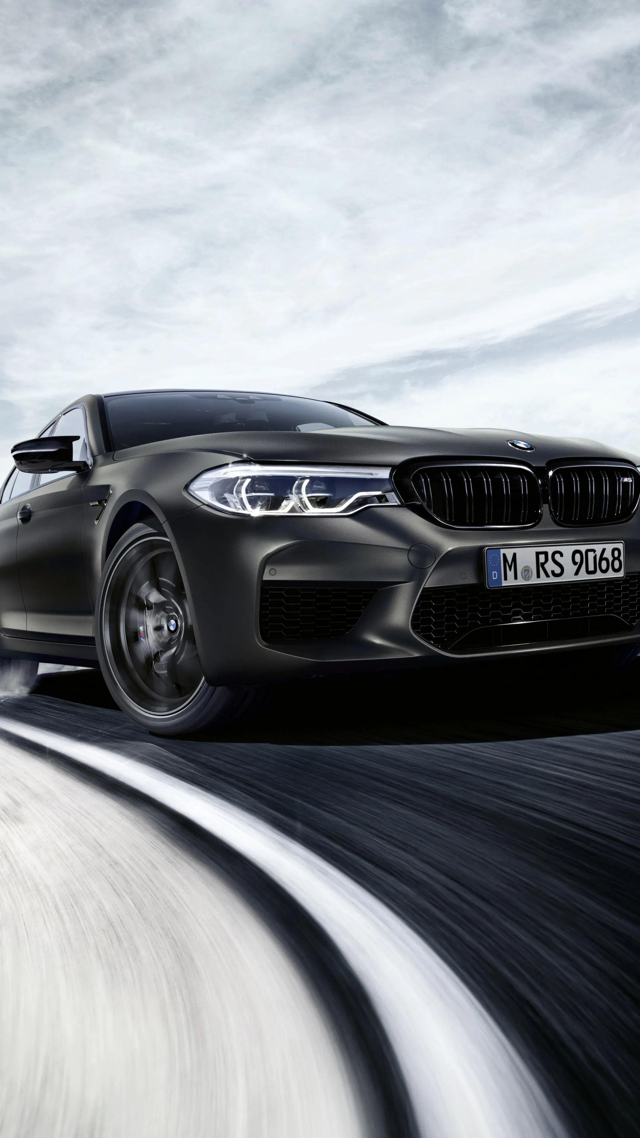 Black Bmw Drifting Fast on a Snow Covered Mountain Curve
