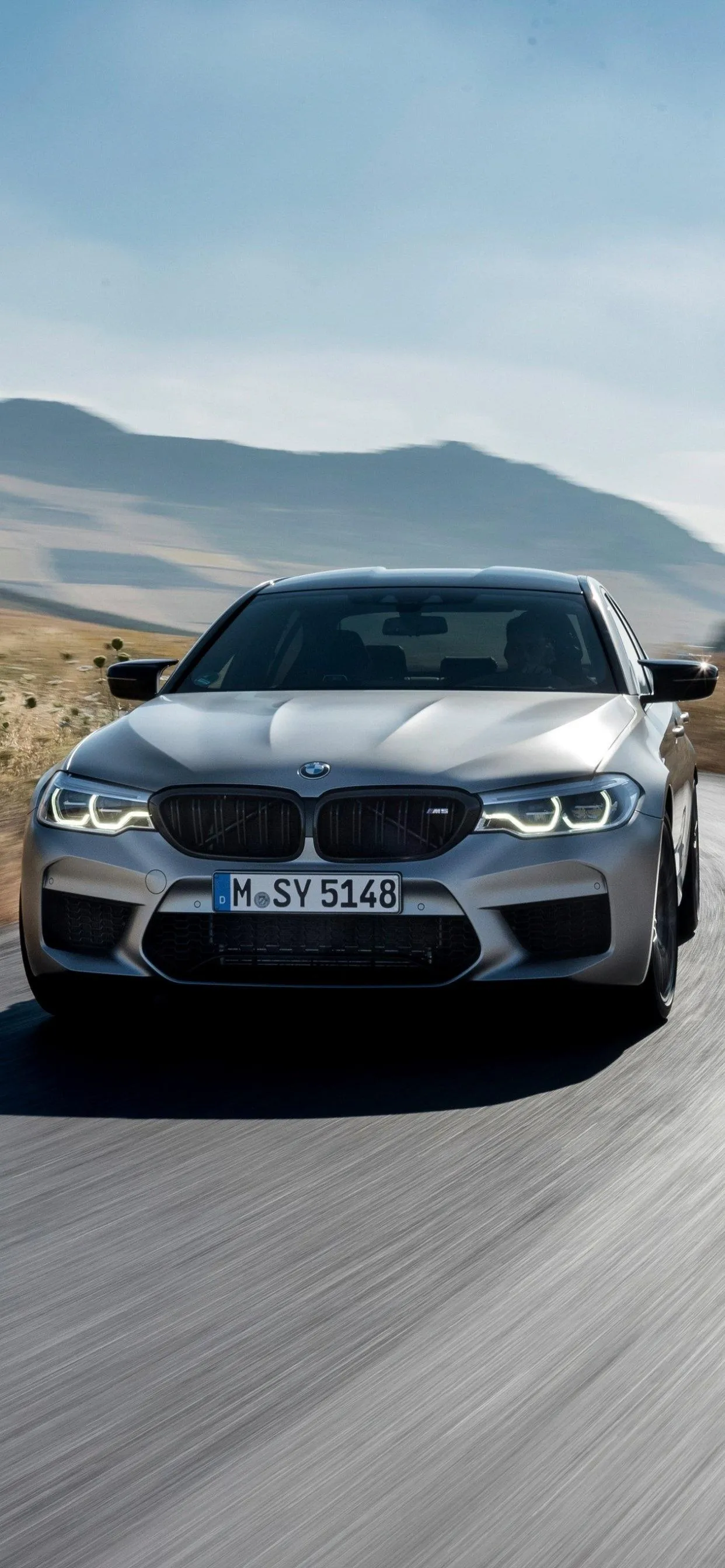 Black Bmw Driving Fast on a Sunny Remote Highway Image