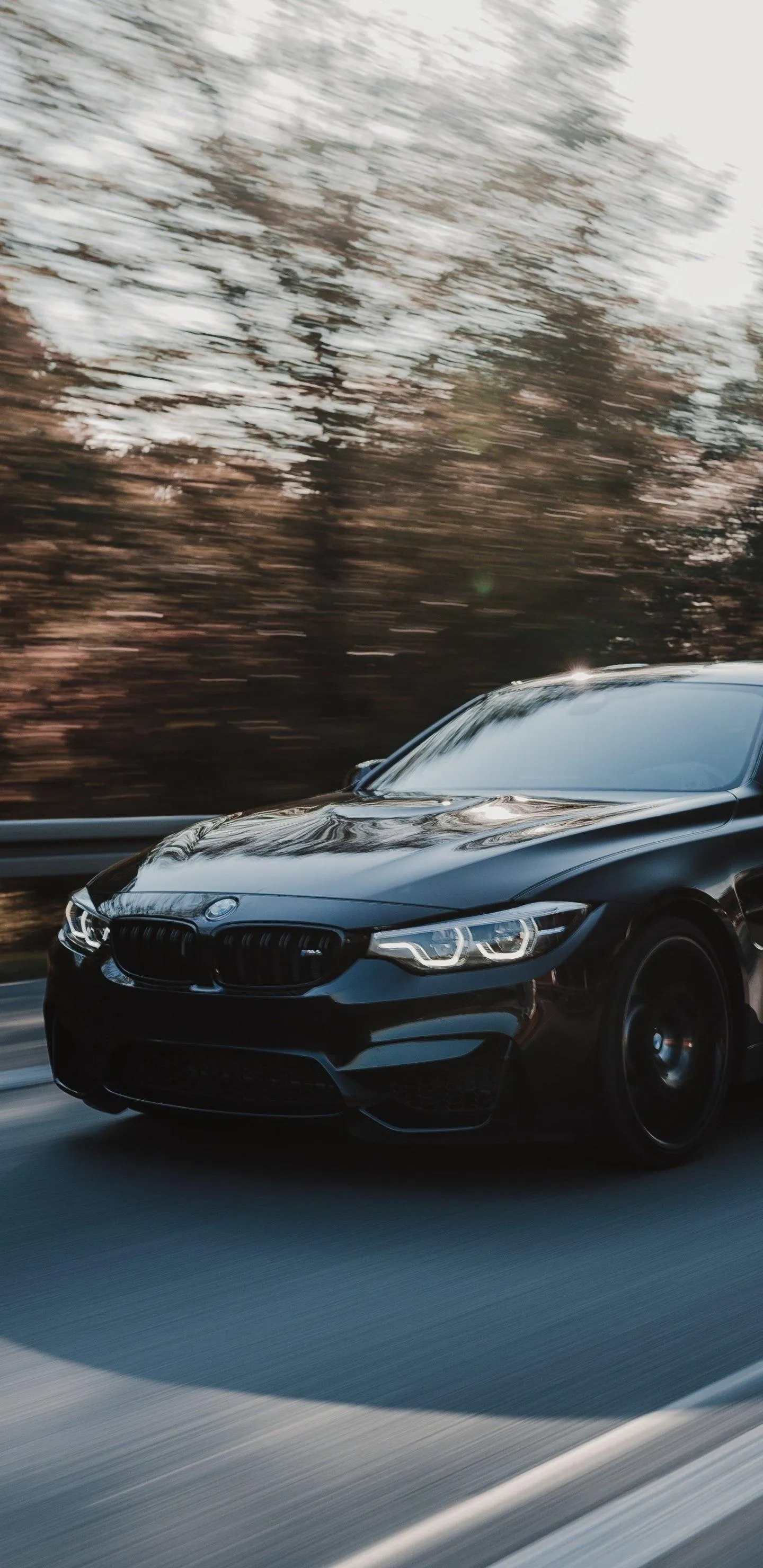 Black Bmw Driving Fast on Road with Motion Wallpaper