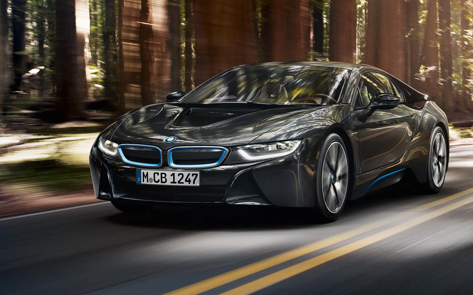 Black Bmw I8 Cruising Through Tree Lined Country Road