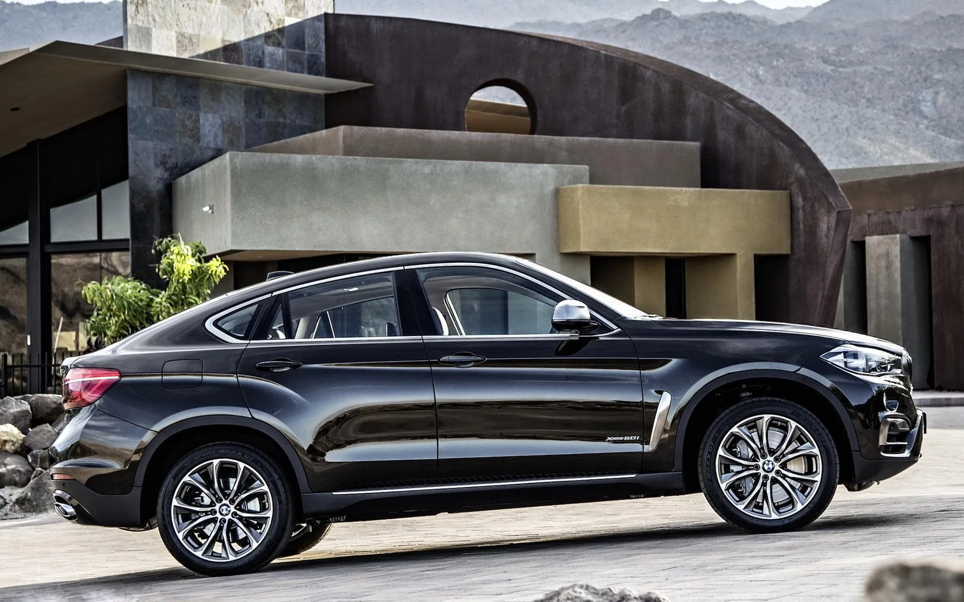 Black Bmw Luxury Suv Parked in Front of Modern House