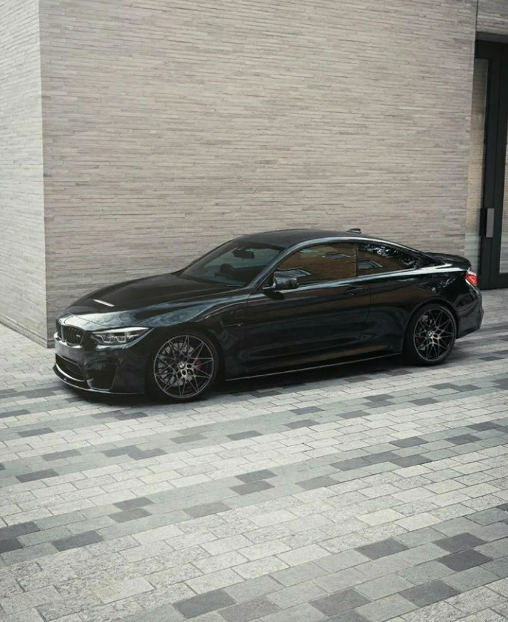Black Bmw Parked in Clean Driveway Outside Modern Home