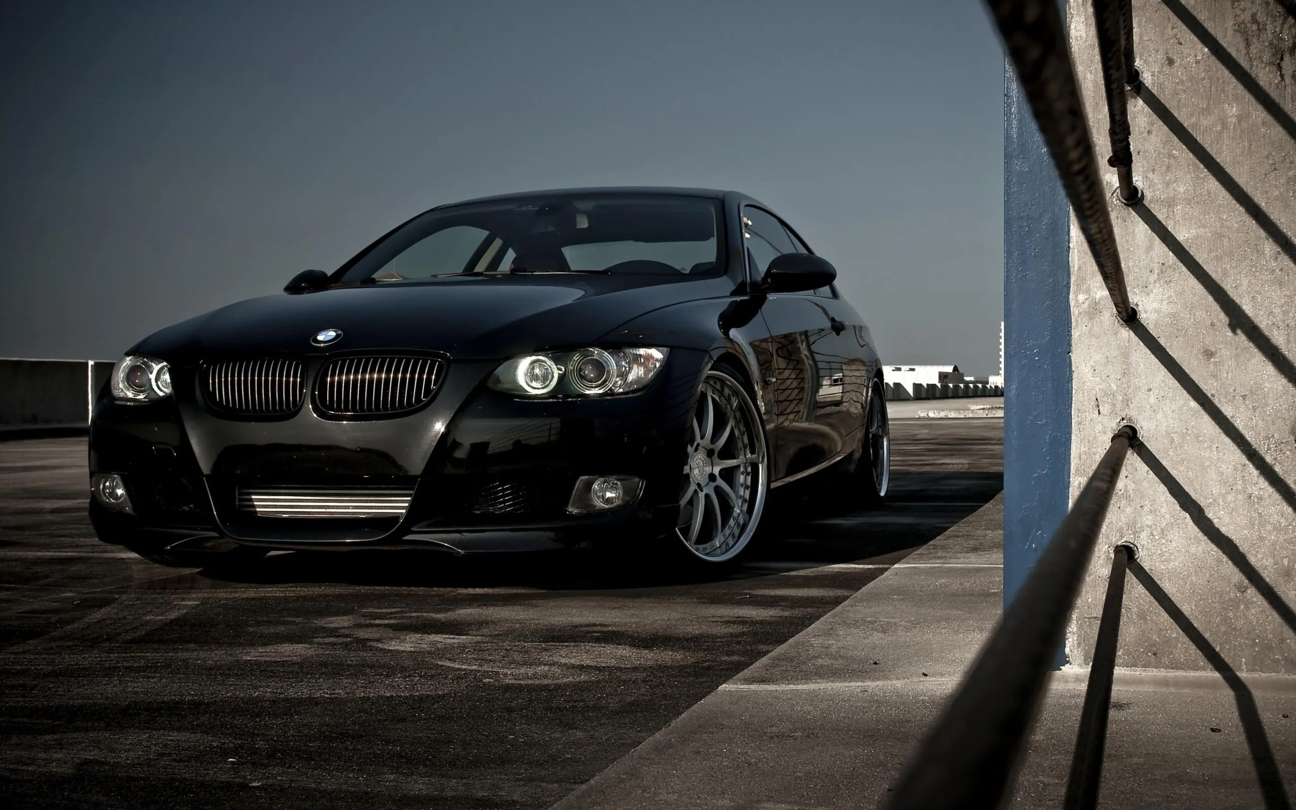 Black Bmw Parked Near a Modern Building in Low Evening Light