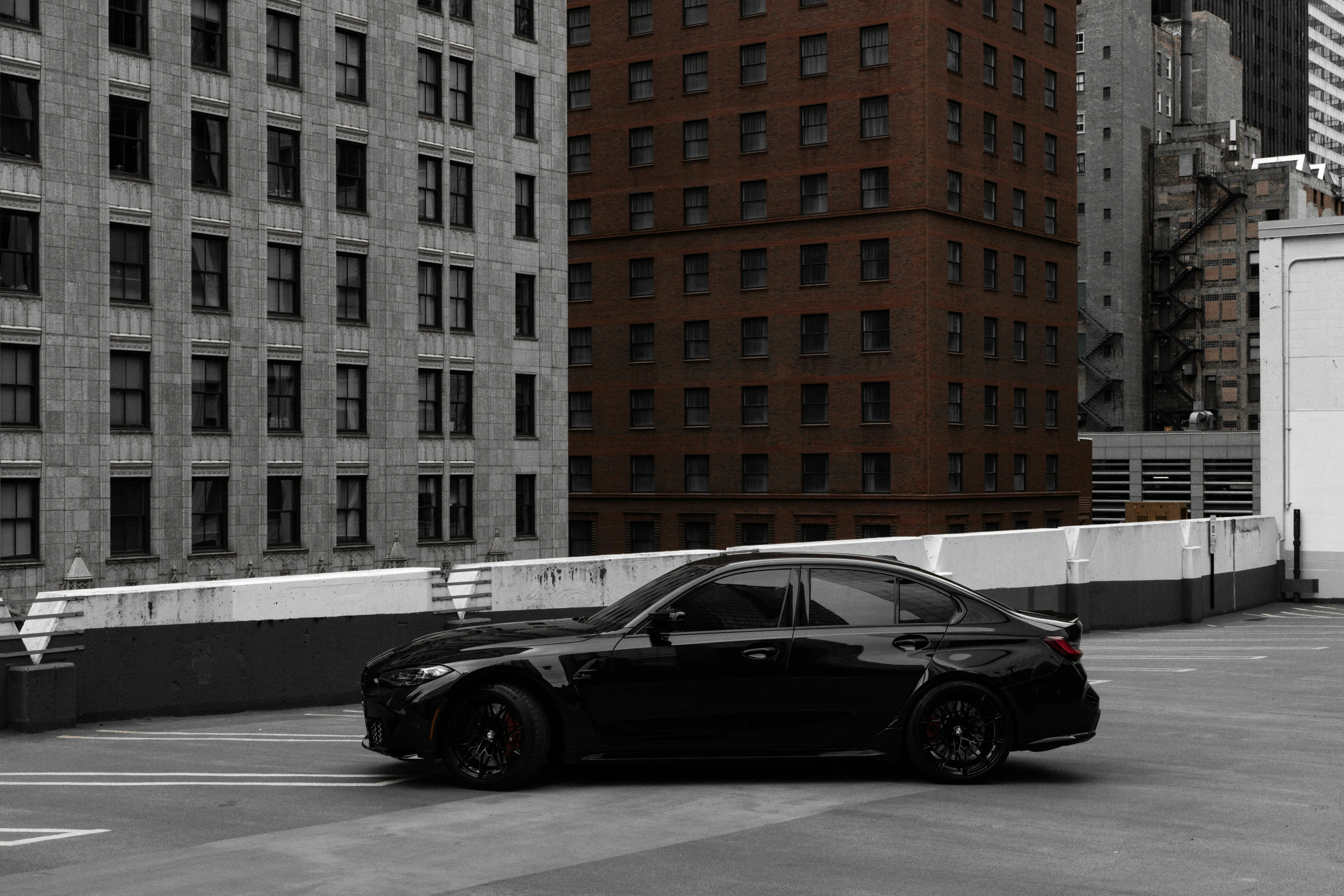 Black Bmw Parked on Urban Street with City Buildings View
