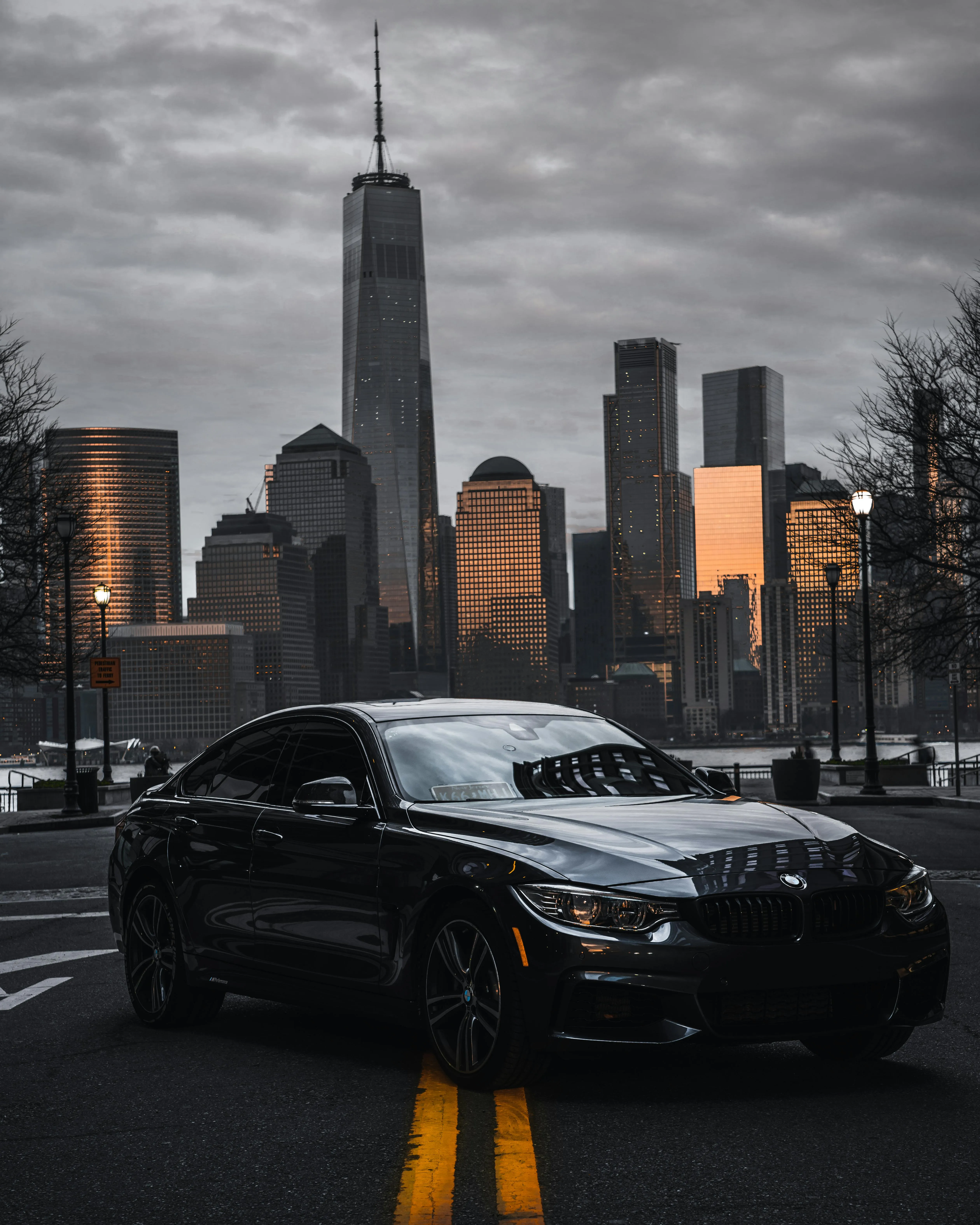 Black Bmw Posed on Empty Road with City Skyline Image