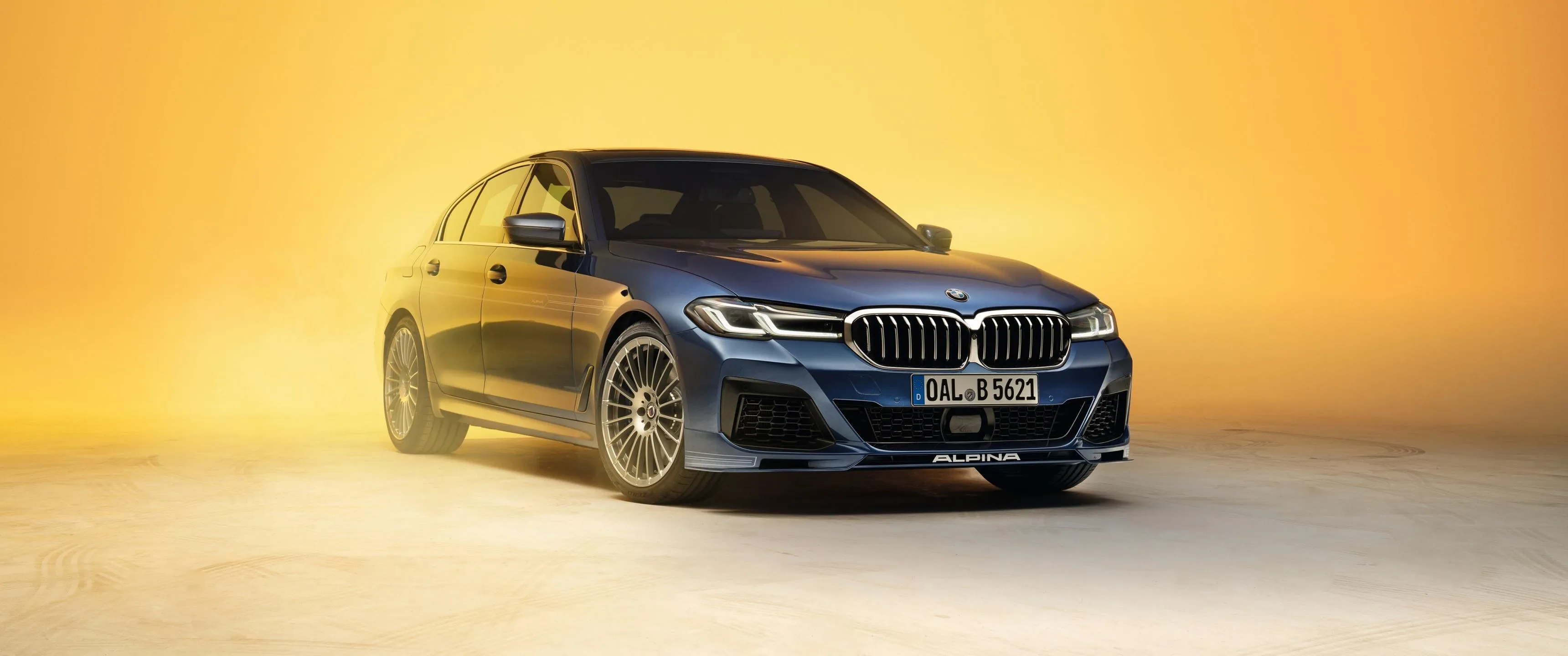 Black Bmw Sedan on a Yellow Backdrop For a Shoot Image