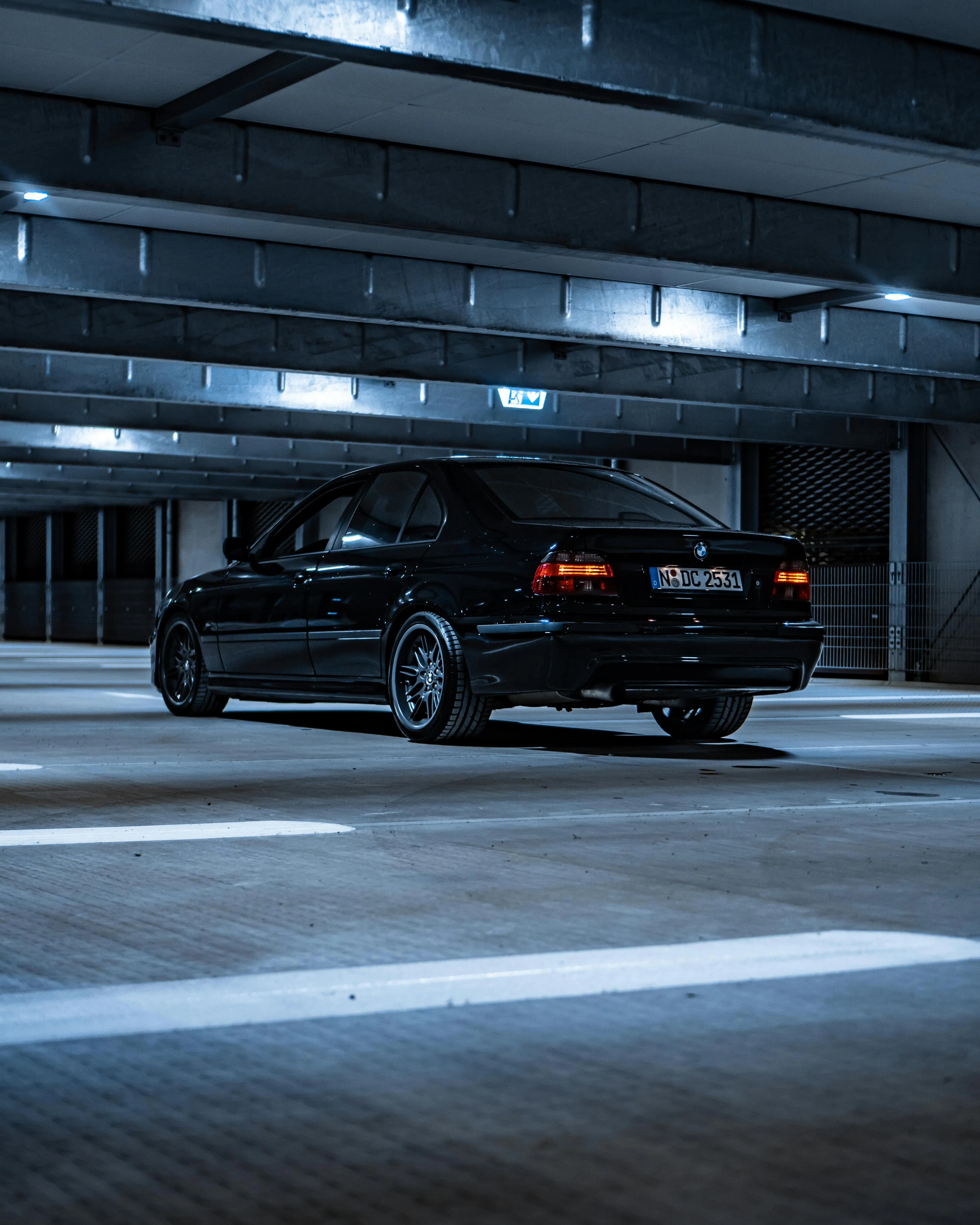 Black Bmw Sedan Parked in a Modern Urban Parking Area