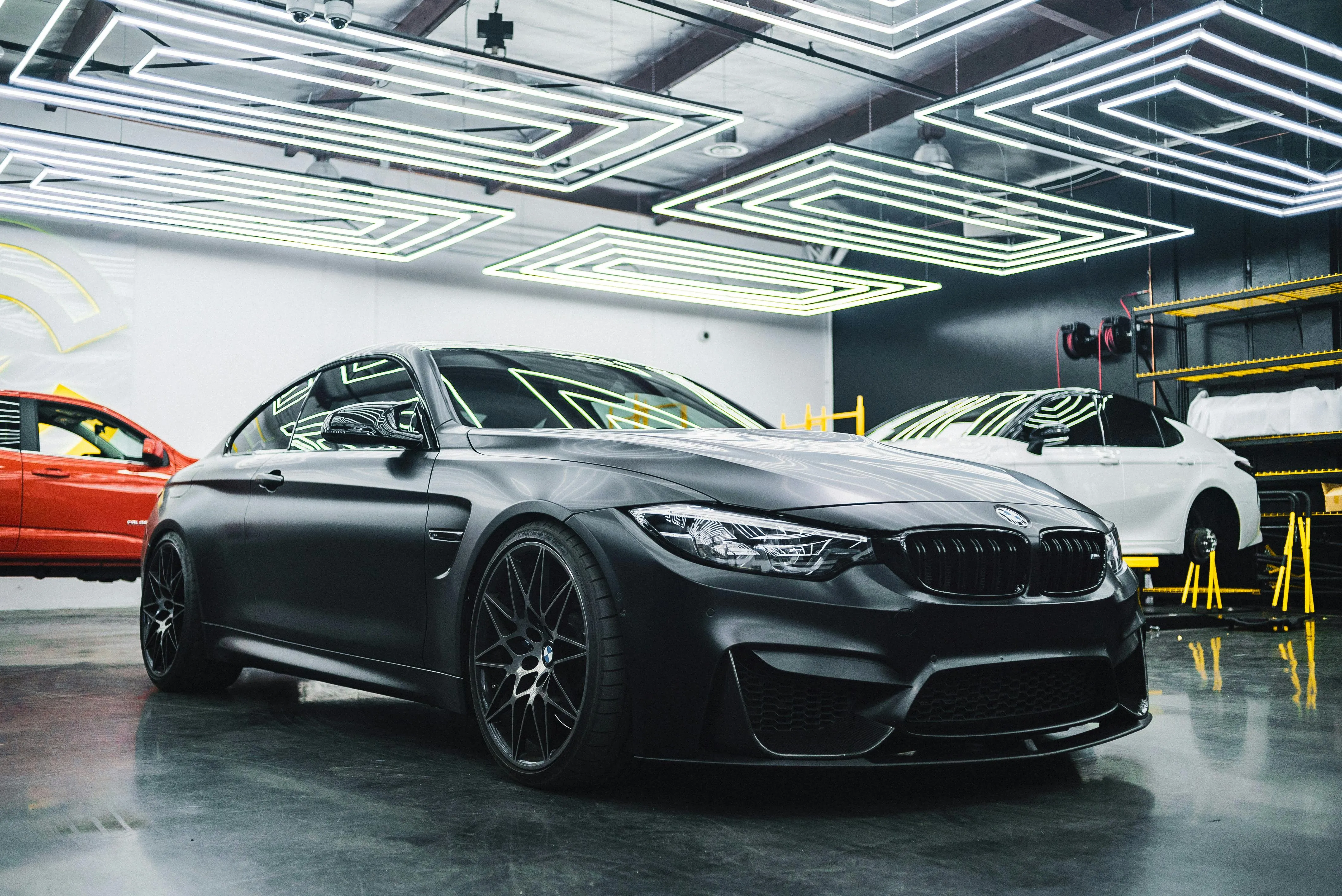 Black Bmw Sedan Parked Inside a Well Lit Showroom Image