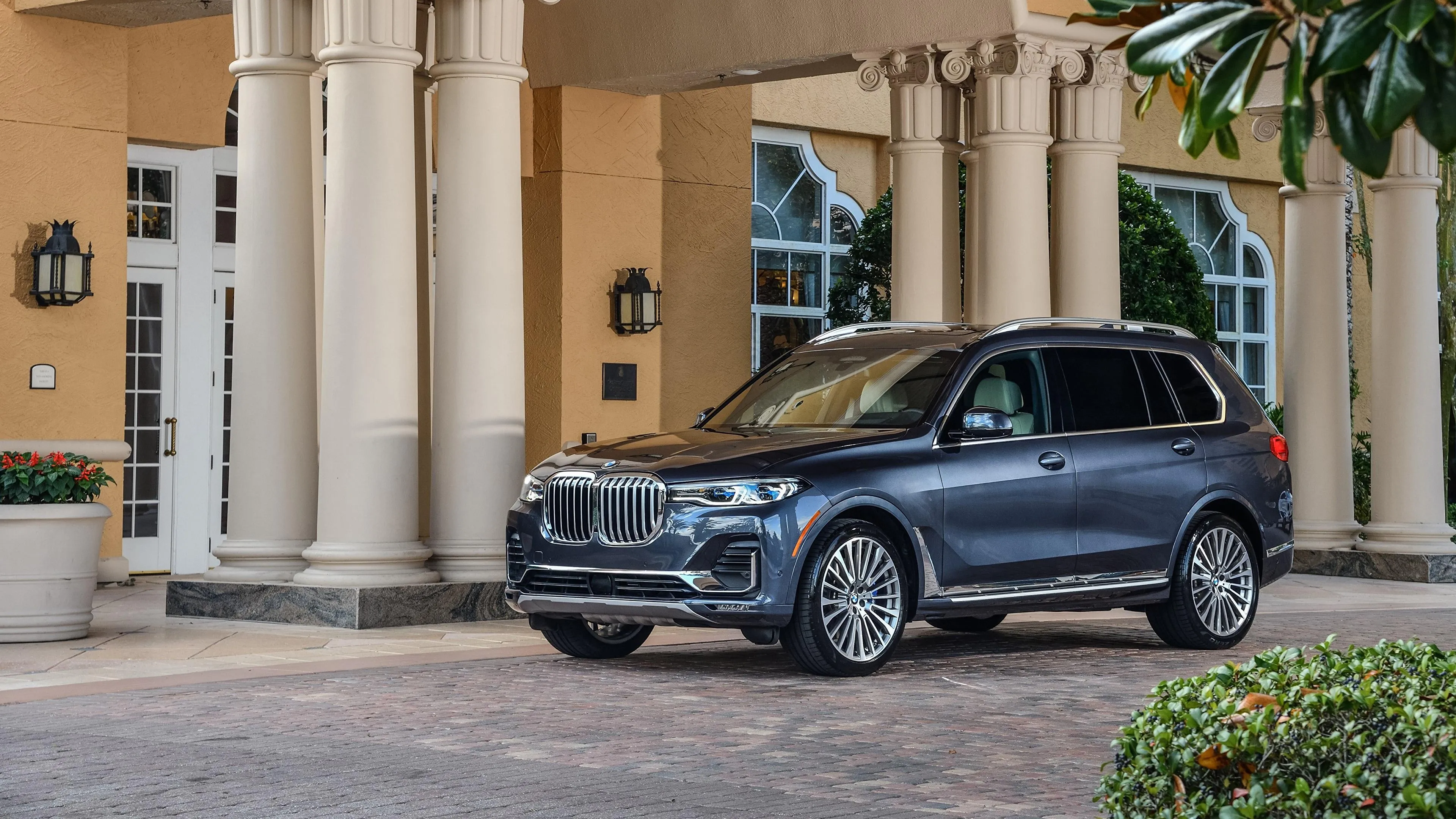 Black Bmw Sedan Parked Near Luxury Villa with Columns
