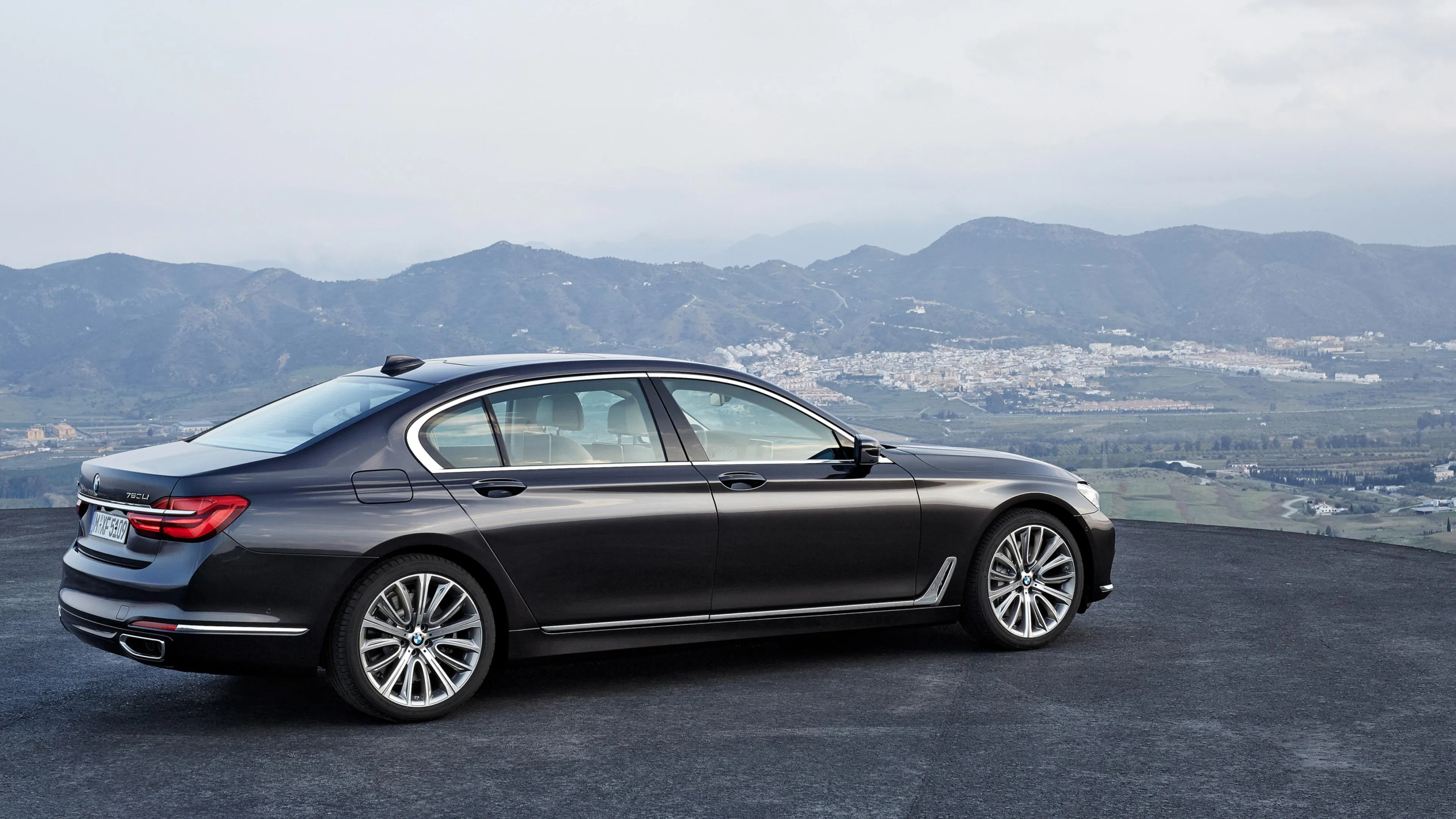 Black Bmw Sedan Parked with Mountain Lake in Background