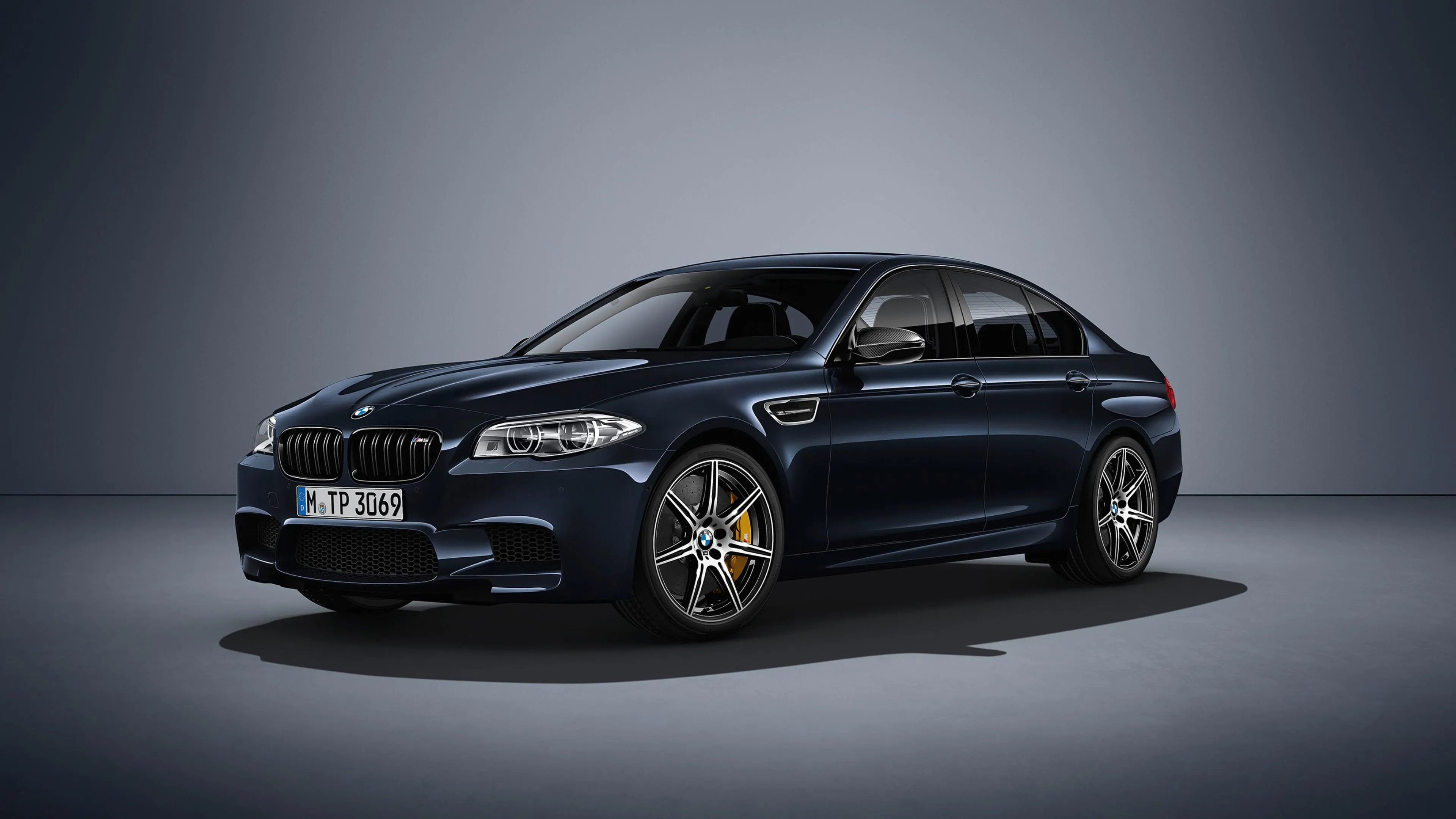 Black Bmw Sedan Photographed in Dark Moody Studio Setting