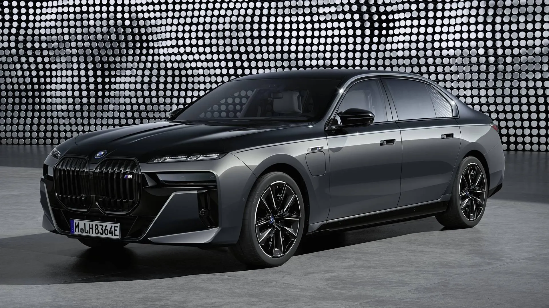 Black Bmw Sedan Posed Against a Plain Urban Background