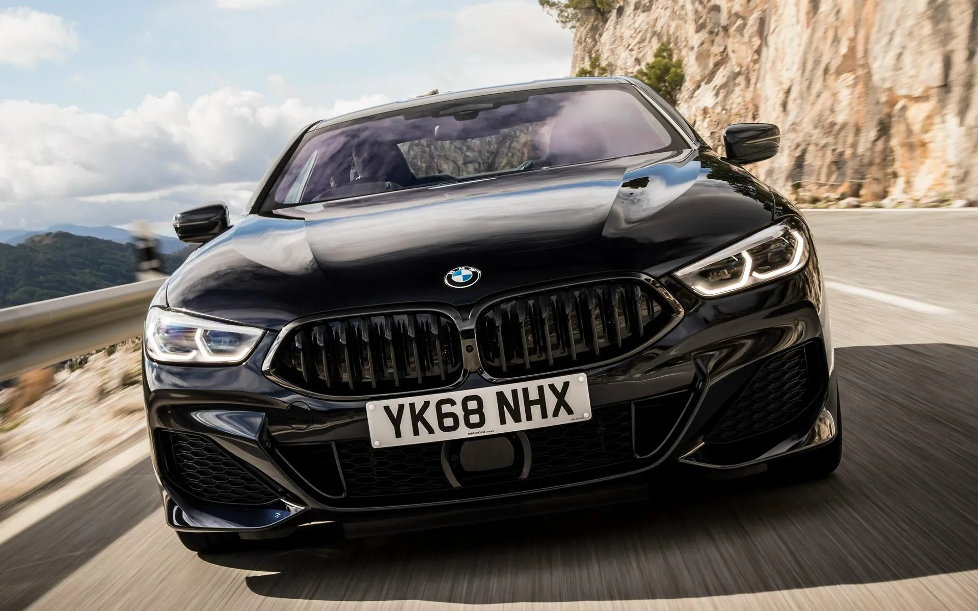 Black Bmw Sedan Turning on Scenic Mountain Road Wallpaper